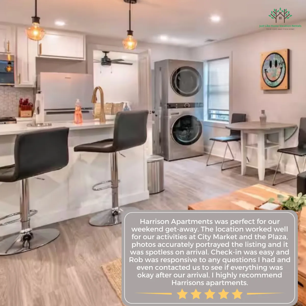A spacious kitchen and dining area with a kitchen island accompanied by bar stools and a dining table. The layout encourages both meal preparation and socializing, with comfortable seating and inviting decor. The washer and dryer hint at modern convenience without distracting from the main kitchen features.